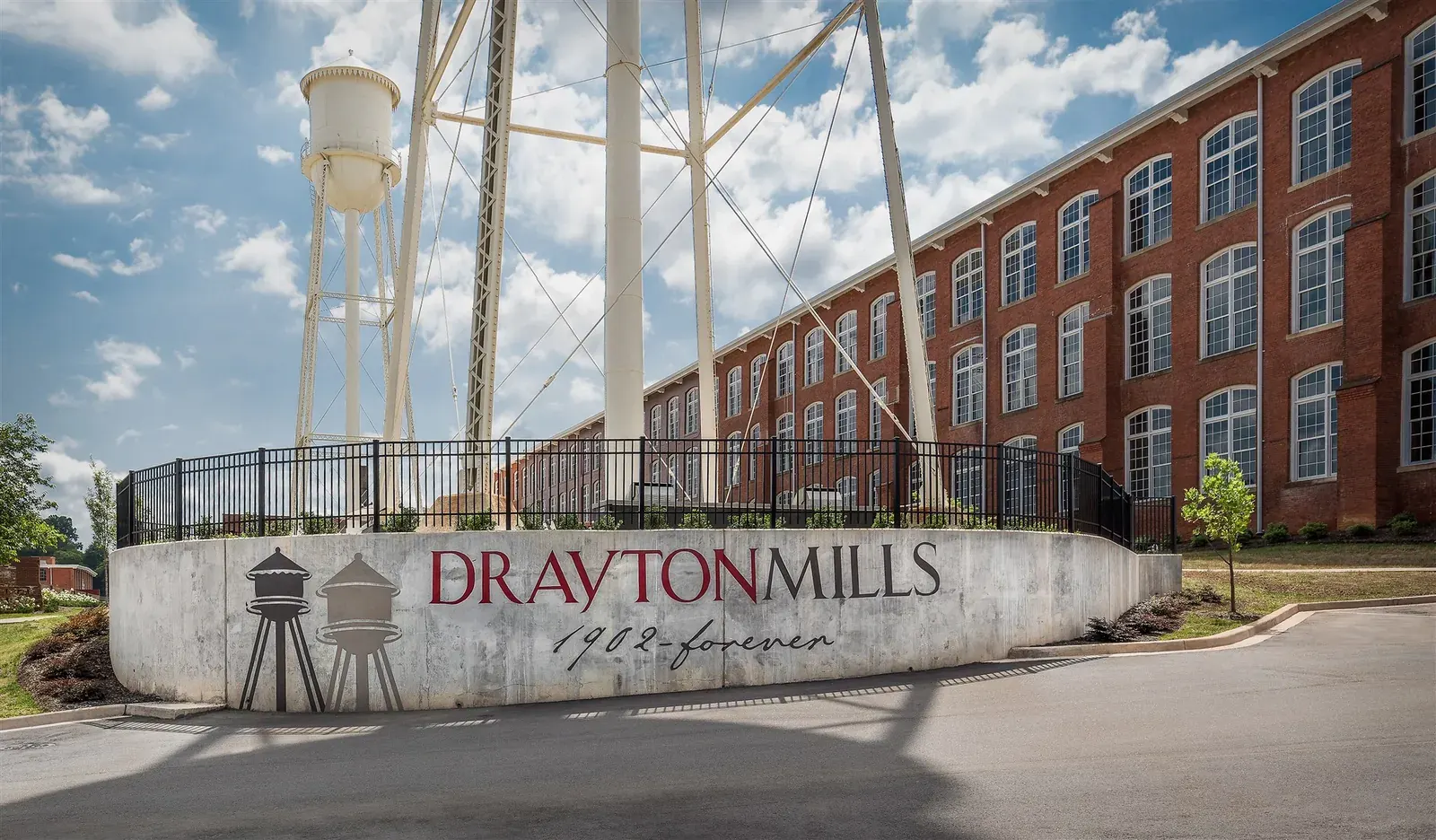 Drayton Mills entrance sign in front of the mill and water tower