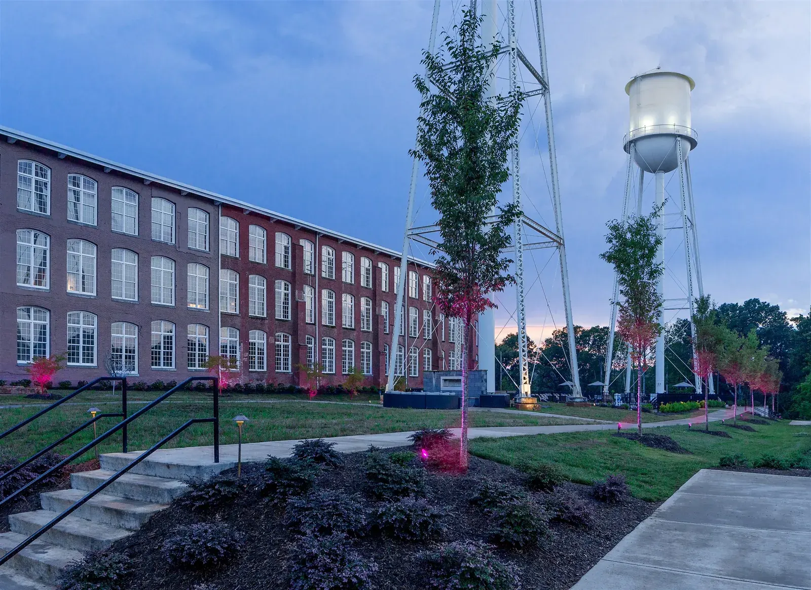 Drayton Mills Lofts at dusk with the illuminated twin water towers